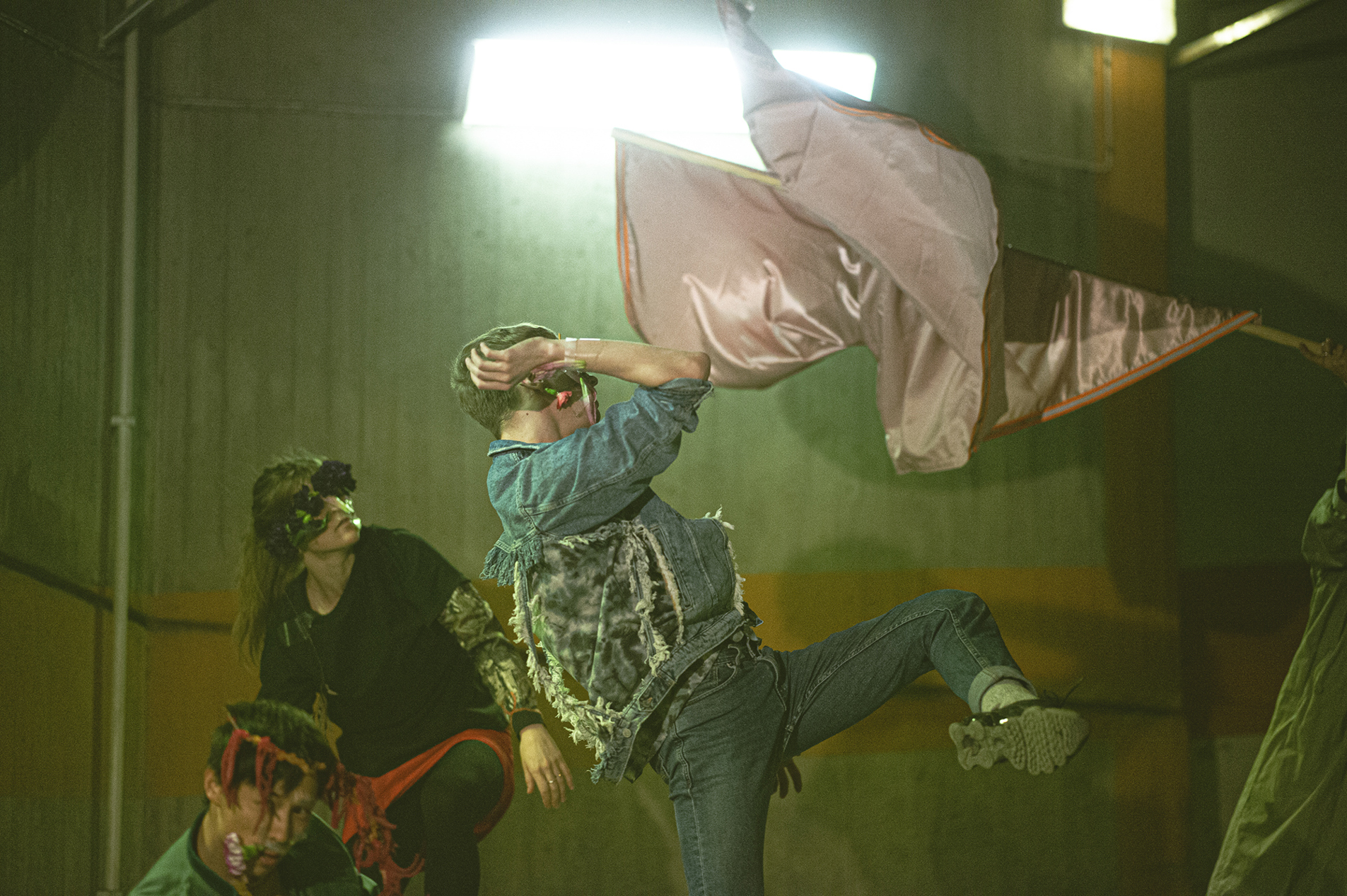 Dancers from the contemporary dance company Norrdans dance with fabrics in a warehouse.